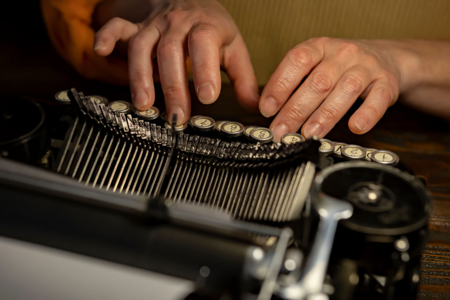 Person typing on a typewriter symbolizing personal storytelling and human rights narratives